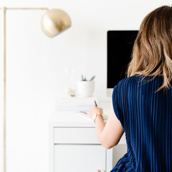 Girl in dark blue dress working on the Desktop Girl in dark blue dress working on the Desktop